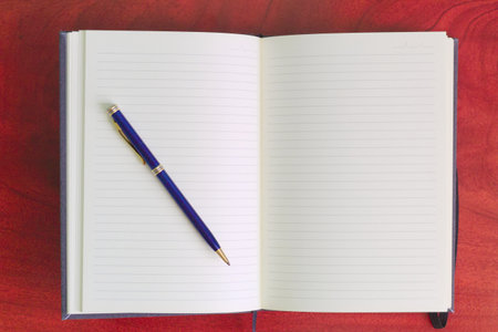 A top view of the blank notepad with a penの写真素材