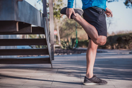 A closeup shot of a Hispanic male doing exercises outdoor