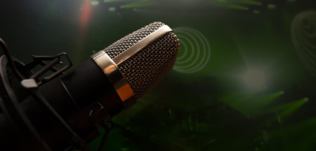 A wide-angle view of a microphone with a pedestal at a party atmosphere with colorful light backgroundの写真素材