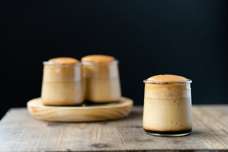 A soft focus of a Japanese style flan made with eggs and honey, and topped with sponge cake