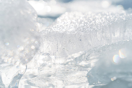 A closeup of transparent shining clear ice pieces sparkling from the sunlightの写真素材