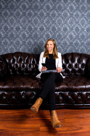 Consultation with pretty blonde psychotherapist on her big sofa in her officeの写真素材