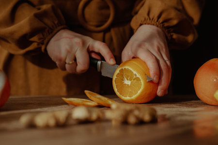 A person cutting oranges on a cutting board