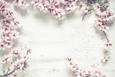 A top view of a White wood textured background decorated with almond rose flowers