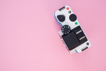 A top view of a photo camera isolated on a pink backgroundの写真素材