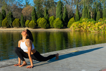 A closeup shot of a young woman practicing yoga in a park on a sunny day