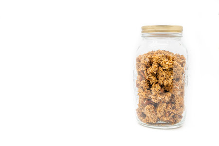 A jar filled with granola isolated on a white backgroundの写真素材