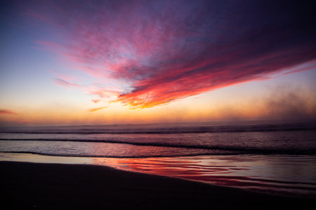 A view of the magnificent vibrant sky over the sea at sunsetの写真素材