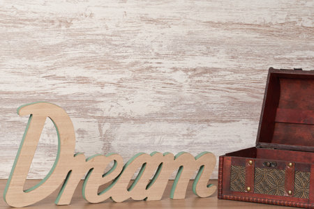 An open treasure chest near a wooden Dream wordの写真素材