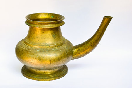 A closeup shot of a Kerala traditional brass vessel on white backgroundの写真素材
