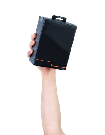 A man's arm raised holding a cardboard box isolated on white background - recycling concept