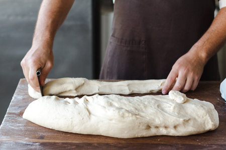 The baker preparing pastry from the dough