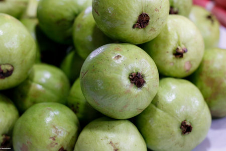 A closeup shot of a pile of fresh guava at a market