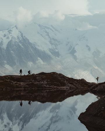 A vertical shot of travelers hiking at the French Alpsの写真素材
