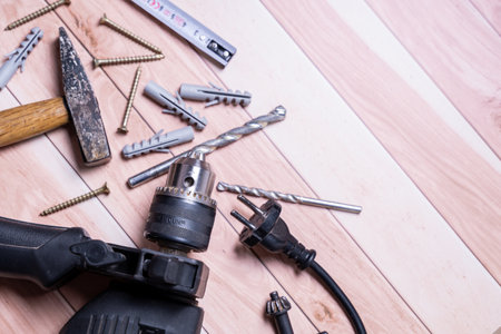 An electrical drill and its set on a wooden table