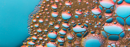 A macro shot of soap bubbles on a blue background