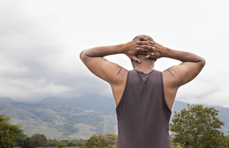 African American Colombian Latino Fitness Man Observing Mountains With Arms Crossed Behind Neck