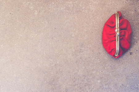 A vintage clutch bag with a clasp on a concrete background with space for textの写真素材