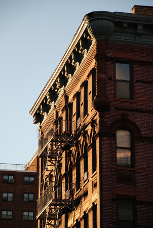 Typical red brick building with fire escape in Manhattan, New York City