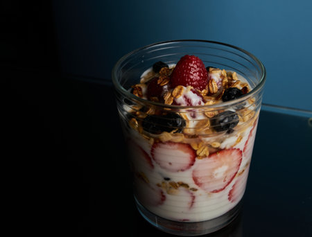 A closeup shot of yogurt with cereals and berriesの写真素材