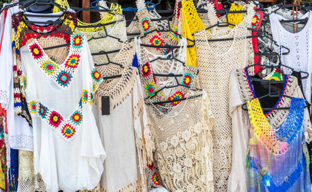 A closeup shot of beach dresses in a market
