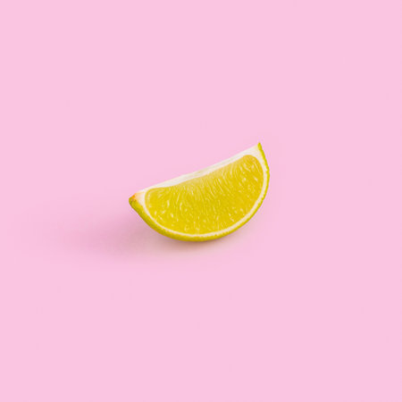 A lemon slice isolated on pink backgroundの写真素材