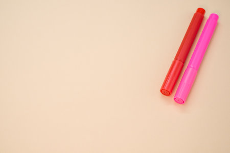 A closeup shot of markers isolated on a pink backgroundの写真素材