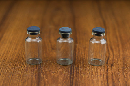 A closeup shot of empty containers on a wooden table - covid19 conceptの写真素材