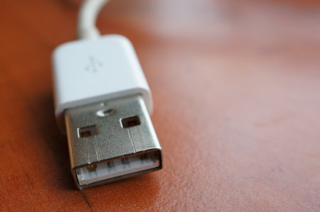 A USB plug on a wooden background