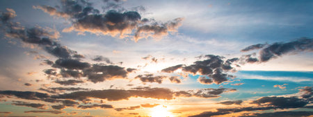 A panoramic shot of a mesmerizing cloudscape at sunset