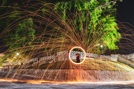 A mesmerizing shot of a Hispanic young man making steel wool fireworks