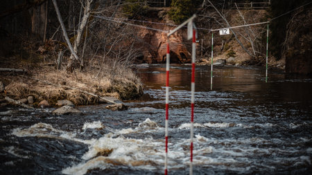 A closeup shot of the gate of whitewater slalom over the rough riverの写真素材