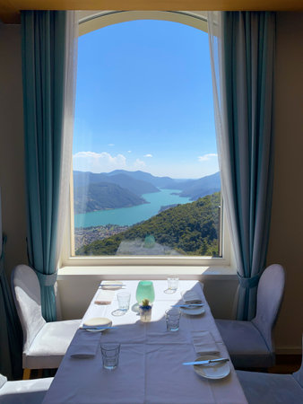 Window View over Alpine Lake Lugano and Mountain in Ticino, Switzerland.