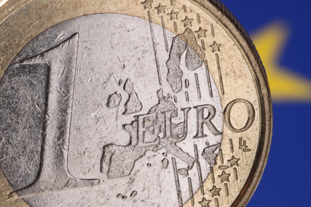 A closeup shot of a Euro coin on a blurred blue backgroundの写真素材