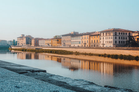 The beautiful old buildings reflected on the water in Florence, Italyの写真素材