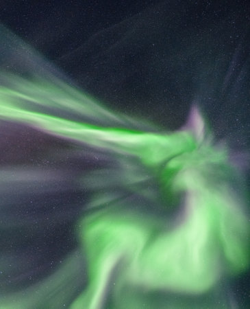 A vertical shot of a green and purple northern aurora lightsの写真素材