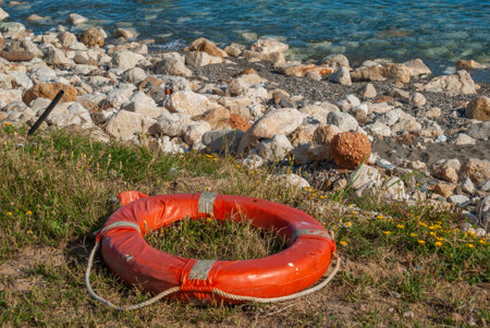lifejacket abandoned on the beach remains of a rescueの写真素材