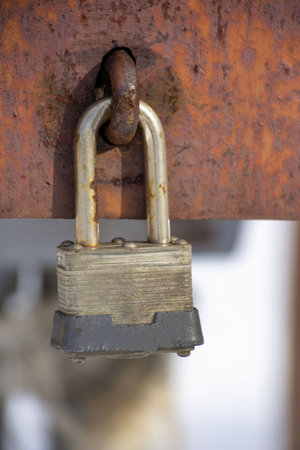A closeup shot of weathered rusty padlockの写真素材