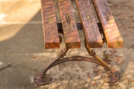 A selective focus shot of a weathered bench outdoorsの写真素材
