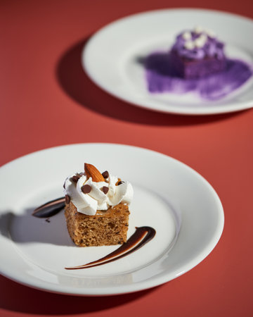 A vertical shot of decorated sweet cake served on white platesの写真素材