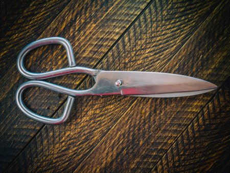 A top view of kitchen shears on a wooden backgroundの写真素材
