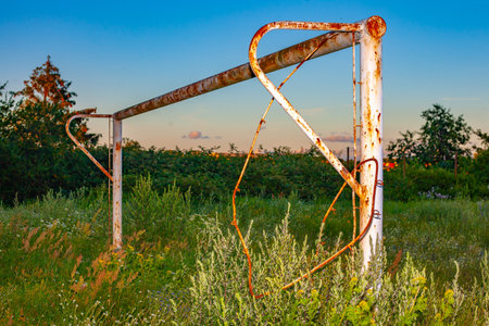 A rusty white goal post on a fieldの写真素材