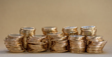 A closeup shot of stacked coins on a tableの写真素材