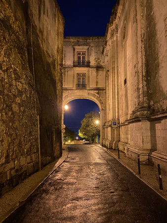 A vertical shot of the famous Arco de Sao Vicente in Lisbon, Portugal, during the night