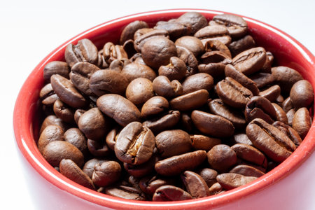 A cup of coffee beans isolated on a white background