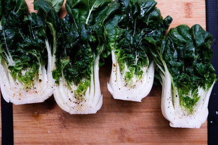 A high angle shot of a sliced organic bok choy ready to cook