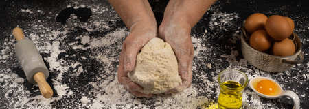 homemade bread dough with flour, salt, egg, water and yeast, with a black background