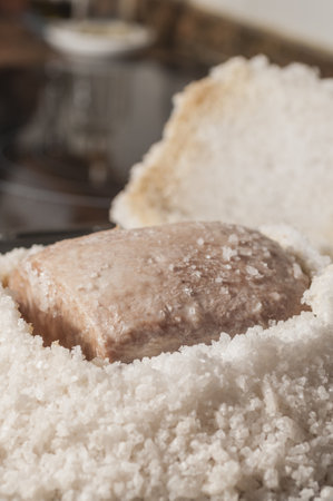 A vertical shot of pork tenderloin baked in saltの写真素材