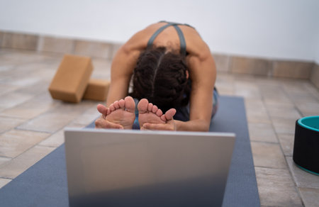 A closeup shot of a white Caucasian woman exercising on a blue matの写真素材