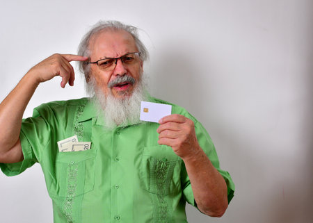 Old American male holding a credit card and trying to remember where he spent his money
